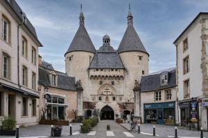 a large building with two towers on a street at La bulle urbaine in Nancy