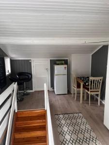 a room with a kitchen and a table and a refrigerator at Koia Guesthouse in Flesberg +15 photos