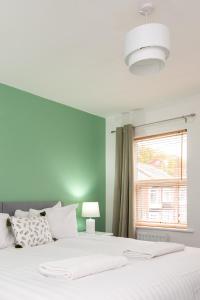 a bedroom with a large white bed with a window at Brancepeth Place in Shildon