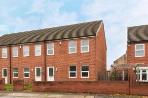 a red brick building with a black roof at Brancepeth Place in Shildon