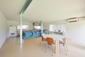 a kitchen and dining room with a table and chairs at Makiba in Hokuto
