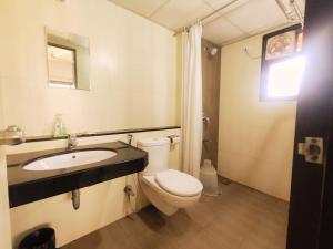 a bathroom with a toilet and a sink at Private Rooms In Blue Ridge in Hinjewadi +16 photos