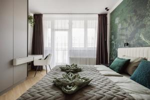 a bedroom with a large bed with plants on it at Designer's Retreat in Buda in Budapest