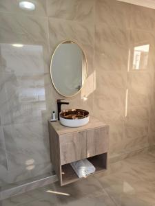 a bathroom with a sink and a mirror at Sekret Zone Hotel in New Germany +26 photos