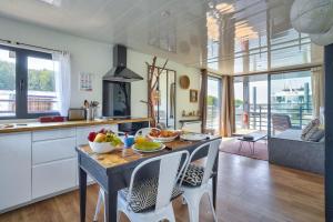 a kitchen with a table with bowls of fruit on it at HouseBoat - Une maison sur l'eau in Conflans-Sainte-Honorine