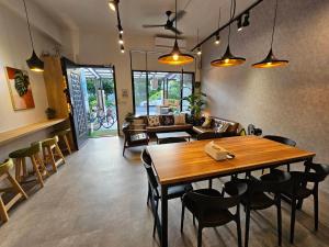 una sala da pranzo con tavolo e sedie in legno di On My Way Taitung Hostel a Città di Taitung