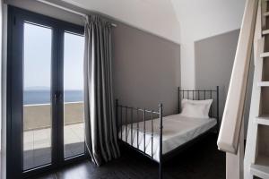 a bedroom with a bed and a view of the ocean at Mythique Pool Residence in Foinikiá +38 photos