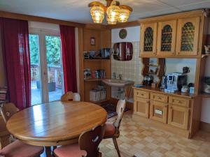 a kitchen with a wooden table and a sink at Montahaus Retro Apartments in Vandans