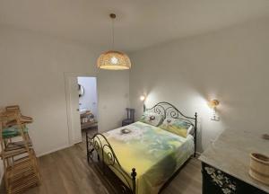 a bedroom with a bed and a table and a lamp at Villa Stefania in Magomadas