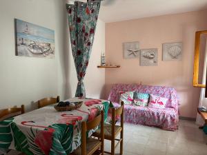 a living room with a table and a couch at Villaggio Malfidano in Buggerru