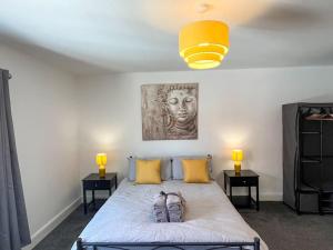 a bedroom with a bed with two night stands and two lamps at 8 Nantwich Road in Crewe