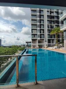 a large blue swimming pool on the balcony of a building at Kuching Gala City Apartment in Kuching