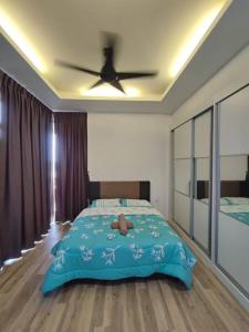 a bedroom with a bed and a ceiling fan at Kuching Gala City Apartment in Kuching
