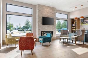 a waiting room with chairs and a fireplace at Comfort Inn Fairbanks in Fairbanks
