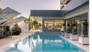 a house with a swimming pool next to a building at Alasia Boutique Hotel in Limassol