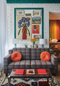 a living room with a couch and a table at Graduate by Hilton Lincoln in Lincoln