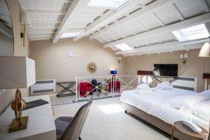 a bedroom with a large bed and a tv at Lanterne Magiche Ortigia Suites in Siracusa +132 photos
