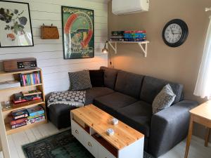 a living room with a couch and a coffee table at Kullahalvön nära Jonstorps hamn in Jonstorp