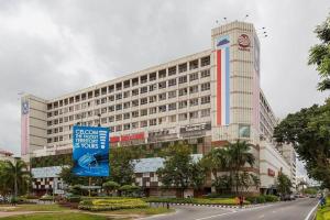 a large building with a clock tower in front of it at API API APARTMENT HOMESTAY BESIDE CENTRE POINT 1BR 3Pax in Kota Kinabalu