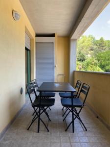 a table and chairs in a balcony with a window at Fontana Apartment in Perugia