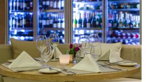 a table with wine glasses and napkins on it at Alasia Boutique Hotel in Limassol