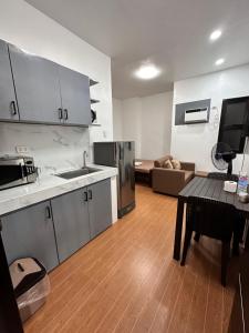 a kitchen and living room with a table and a couch at RJC Building in Olongapo