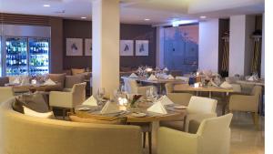 a dining room with tables and chairs and tablesktop at Alasia Boutique Hotel in Limassol