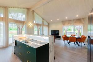 a kitchen and dining room with a table and chairs at Kolmnurga Villa in Audru