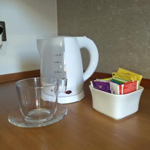a coffee maker and a glass on a table at Putignani 210 Apartment in Bari