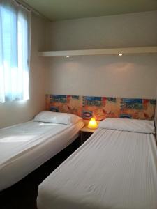 A bed or beds in a room at Villaggio Camping Europa