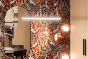 a hallway with a wall with a mirror and a table at Green Garden Sauna Apartment in Brno +38 photos