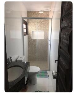 a bathroom with a shower and a toilet and a sink at Vicentina Hospedagem in Tiradentes