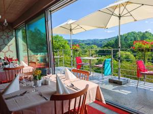 a restaurant with tables and chairs with a view at Hotel Rajská zahrada in Nové Město nad Metují