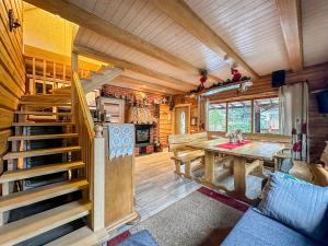 a room with a table and a staircase in a cabin at Pirtelė Rykštelė in Karmėlava