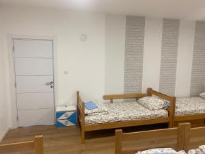 a room with two bunk beds and a door at Dušanov konak in Vrbas