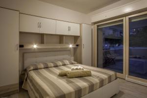 a bedroom with a bed with two teddy bears on it at Residences del teatro in Cagliari