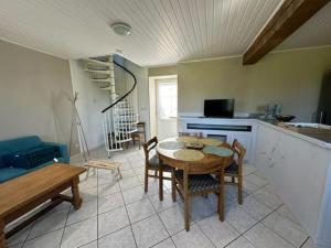 a kitchen with a table and chairs in a room at Maison campagne Normande in Blacqueville