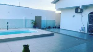 a large room with a swimming pool in a building at Cantinho da Beth in Caravelas