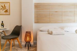 a bedroom with a bed and a chair and a table at AcroLofts M62 in Athens +85 photos
