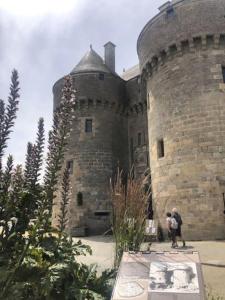 due persone in piedi davanti a un castello di Duplex dans le coeur historique de Guérande a Guérande Altre 12 foto