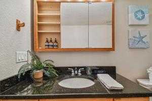 a bathroom with a sink and a mirror at Bayside Penthouse-5min to Beach, Rest & Shops in Clearwater Beach +31 photos