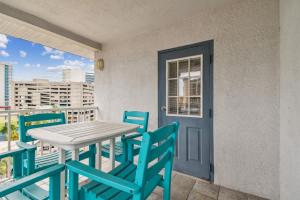 a table and chairs on a balcony with a door at Bayside Penthouse-5min to Beach, Rest & Shops in Clearwater Beach