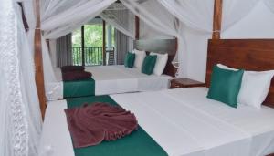 Postel nebo postele na pokoji v ubytování Sigiriya Paradise Inn