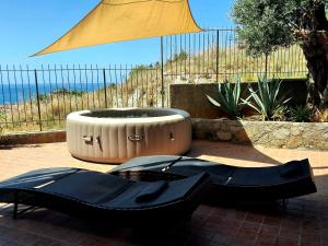 a pair of black shoes sitting next to a large tub at La Dolce Dimora in Praia a Mare