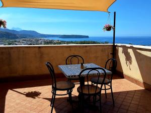 a table and chairs on a balcony with a view at La Dolce Dimora in Praia a Mare