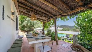 a patio with a table and chairs and a pool at La Casa 1950 Montefrío by Ruralidays in Montefrío
