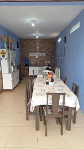 a dining room with a long table and chairs at Pousada JOSHUA in Penha