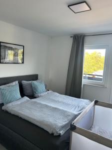 a bed in a room with a window at Ferienwohnung Juli in Medebach