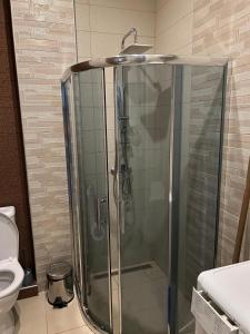 a glass shower in a bathroom with a toilet at Decom Riviera in Shekhvetili