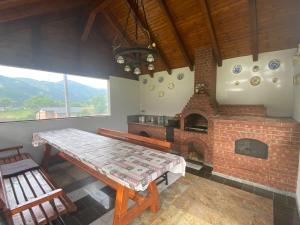 a dining room with a brick fireplace and a table at Pensiunea Simona in Rodna